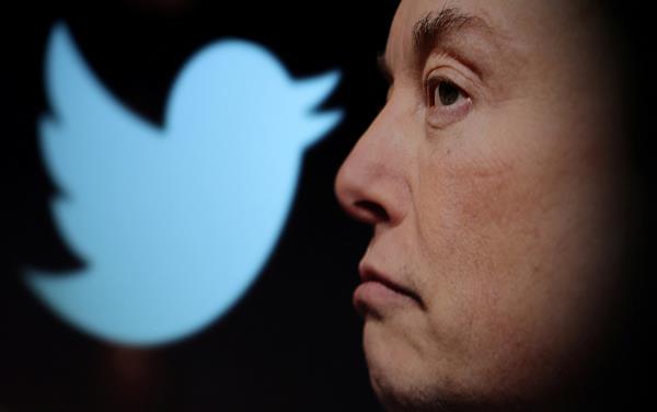 Twitter logo and a photo of Elon Musk are displayed through magnifier in this illustration taken October 27, 2022. (REUTERS/ Dado Ruvic)